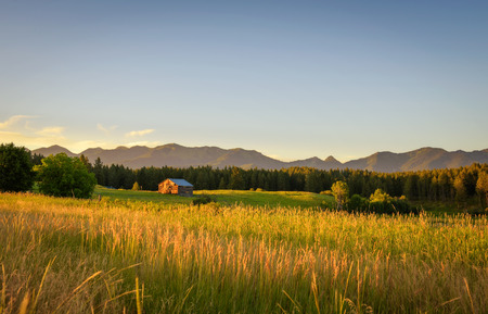 Summer sunset with an old barn in rural Montanaの写真素材