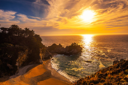 Sunset over McWay Falls on Pacific Coast Highway in Californiaの写真素材