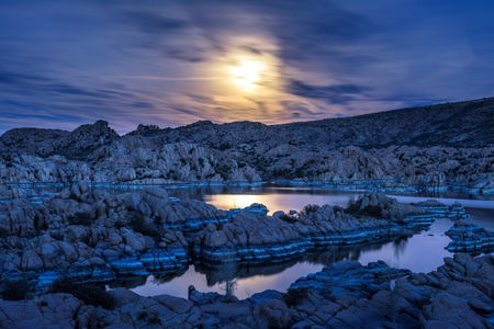 Night sky with full moon above Watson Lake in Prescott, Arizonaの写真素材