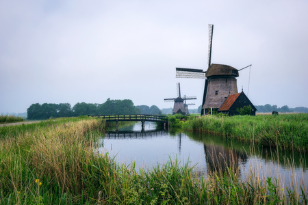 Old dutch windmill in cold morning scenery near Amsterdamの写真素材