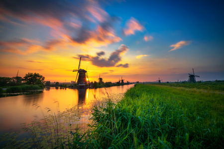 Sunset above old dutch windmills in Kinderdijk, Netherlandsの写真素材