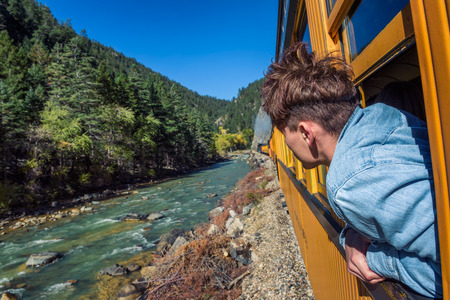 Young man looking out of train window