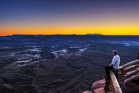 Tourist at the Green River Overlook in Canyonlands National Parkの写真素材