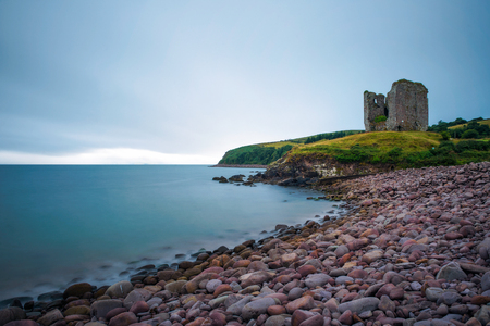 Stone beach and the Minard Castle situated on the Dingle Peninsula in Irelandの写真素材