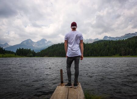 Young tourist overlooking the beautiful alpine Lake of Staz in Switzerlandの写真素材