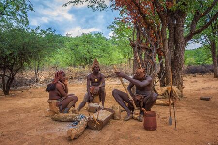 People of the Himba tribe sitting and making their toolsのeditorial素材