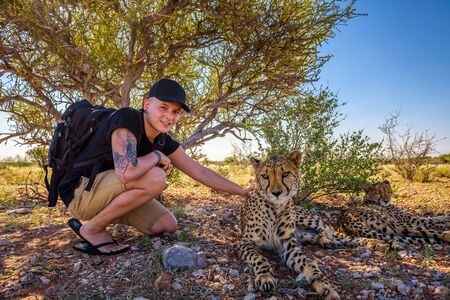 Tourist plays with two cheetahsのeditorial素材