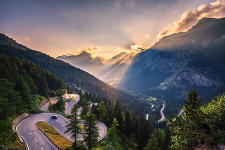 Maloja Pass road in Switzerland at sunsetの写真素材