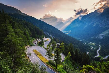 Maloja Pass road in Switzerland at sunsetの写真素材