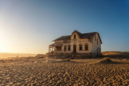 Sunrise above an abandoned house in Kolmanskop ghost town, Namibiaの写真素材