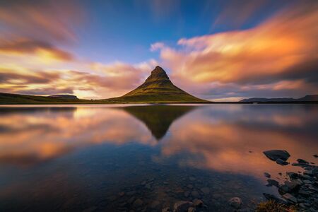 Sunset over Kirkjufell mountain with reflection in a nearby lake in Icelandの写真素材
