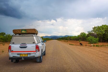 4x4 suv car equipped with a roof tent driving through Kunene Region in Namibiaのeditorial素材