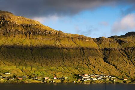 Coastal village of Signabour in sunset light, Faroe Islandsの写真素材