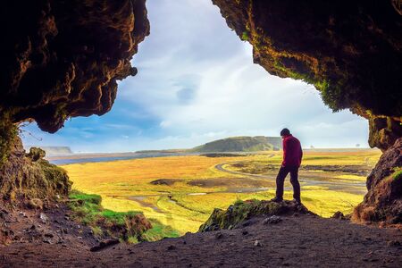 Hiker in the Loftsalahellir Cave near the village of Vik in Icelandの写真素材