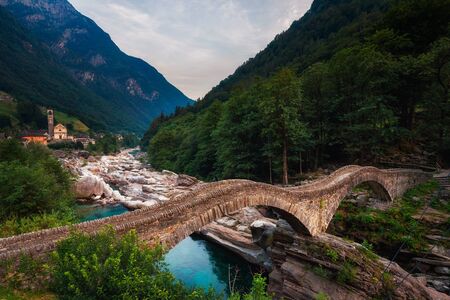 Historic bridge called Ponte dei Salti in the village of Lavertezzo, Switzerlandの写真素材