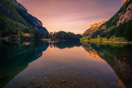 Sunset over the Seealpsee lake in the Swiss Alps, Switzerlandの写真素材