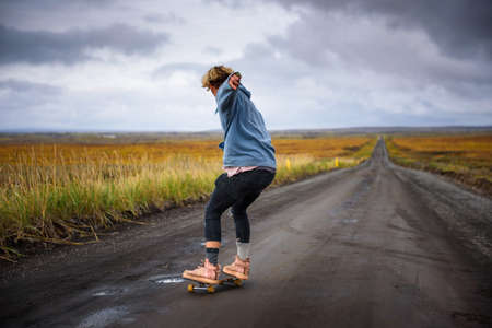 Action shot of a skater on a dirt road in Iceland
