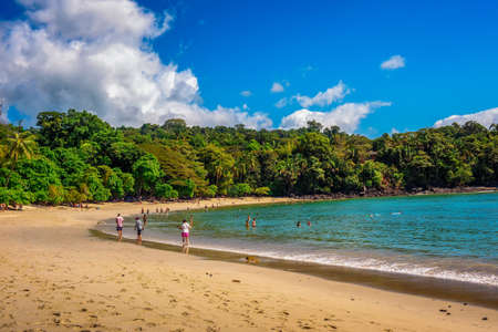 Tropical beach in Manuel Antonio National Park with tourists in Costa Ricaのeditorial素材