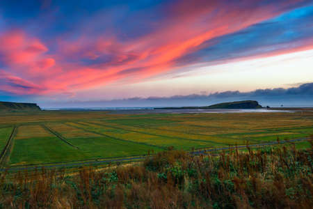 Sunset sky above the coast between Dyrholaey and Reynisfjara beach in Icelandの写真素材