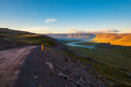 Icelandic landscape with fjord and gravel road at sunset in Westfjords, Icelandの写真素材