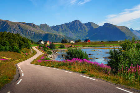 Scenic coastal road through villages and mountains on Lofoten islands in Norwayの写真素材