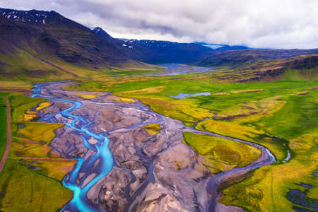 Aerial view of a river flowing through icelandic landscapeの写真素材
