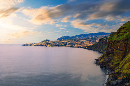 Sunset over the city of Funchal and cliffs of Madeira Islandの写真素材