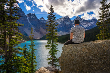 Hiker enjoying the view of Moraine lake in Banff National Parkの写真素材