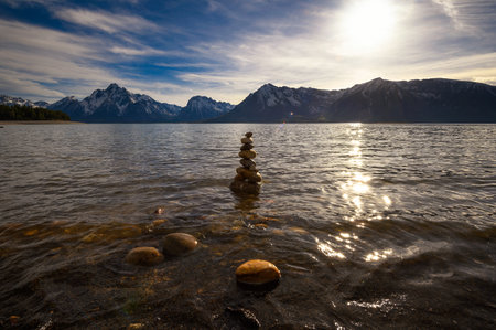 Balanced rock pyramid at the Jackson Lake at sunset, Wyoming, USAの写真素材