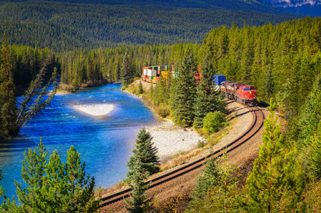 Train passing through Morants Curve in bow valley, Canadaの写真素材