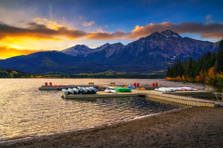 Sunset over jetty with boats on the Pyramid Lake in Jasper National Park, Canadaの写真素材