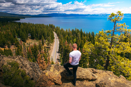 Hiker enjoying the view of Lake Tahoe from the Eagle Rock in Californiaの写真素材