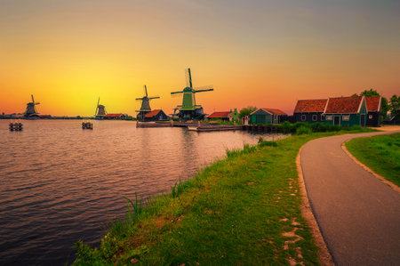 Sunset above farm houses and windmills of Zaanse Schans in the Netherlandsの写真素材