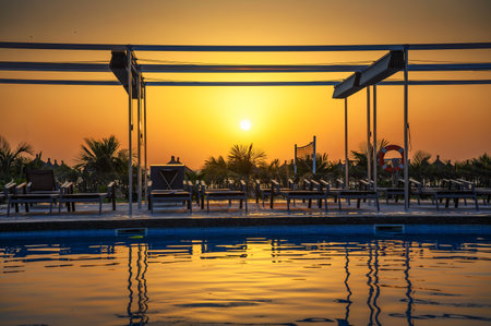 Sunset above a swimming pool, Atlantic Ocean and a beach in Senegal, Africaの写真素材