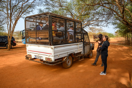 Tourists in a car cage prepare to visit lions in Ranch de Bandia in Senegalのeditorial素材