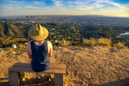 Tourist overlooking the Los Angeles skyline from Mount Lee at sunsetの写真素材