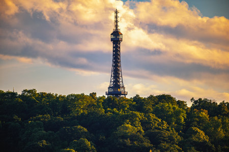 Petrin Lookout Tower rises above the treetops on Petrin Hill in Prague, Czechia, captured during a sunset.の写真素材