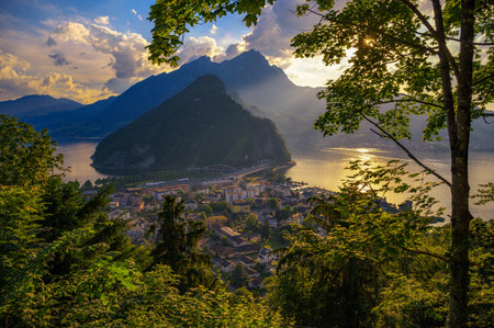 Aerial view of Stansstad and Lake Lucerne in the Canton of Nidwalden, Switzerland, with the Swiss Alps in the background during a golden sunset.の写真素材