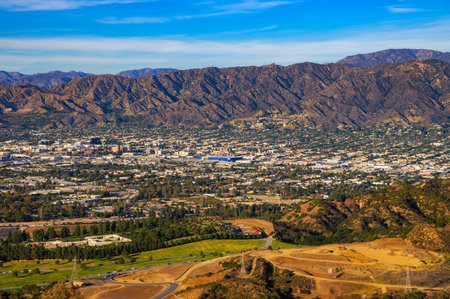 Aerial view of Burbank, California from Mt. Lee at sunset, with the Verdugo Mountains in the backgroundの写真素材