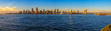 Panoramic view of San Diego skyline across the bay from Coronado Island during sunset.の写真素材