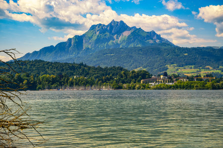 Scenic view of Lake Lucerne from Lido Wiese in Lucerne, Switzerland, with sailboats and Mount Pilatus in the background.の写真素材