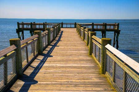 Wooden pier extending into the water at Albert L. Munroe Sr. Pier in Milford, Connecticutの写真素材