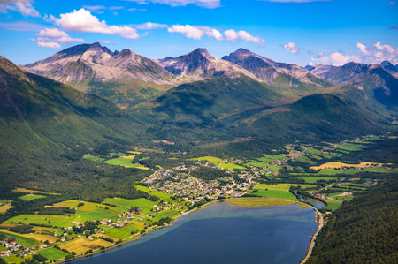 Aerial view from Nesaksla mountain overlooking Isfjorden village and Romsdalsfjorden, surrounded by the Romsdal mountains in Norway.の写真素材