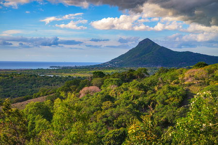 Scenic view of La Tourelle du Tamarin, also known simply as La Tourelle, a prominent mountain on the west coast of Mauritius, surrounded by Indian Ocean, tropical forest and coastal plains.の写真素材