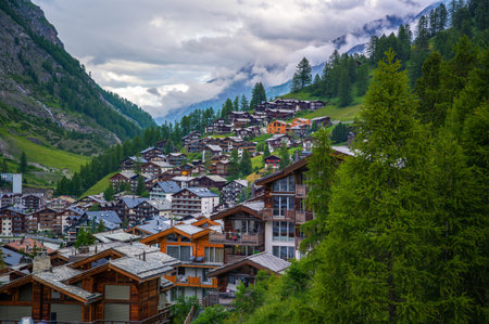 Zermatt, Switzerland with traditional wooden chalets nestled on the hillside surrounded by the Swiss Alps.の写真素材