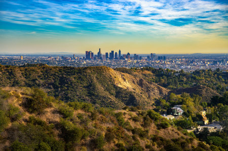 Evening view of downtown Los Angeles from Mt. Lee Drive, California, with foreground hills and scattered homes.の写真素材