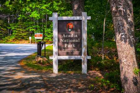 Acadia NP, Maine, USA - June 09, 2025 : Entrance sign for Acadia National Park surrounded by dense forest in Maine, United States.のeditorial素材