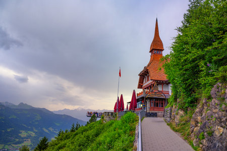 Harder Kulm, Switzerland - June 29, 2024 : Elevated view of the Harder Kulm restaurant and observation platform in Switzerland, overlooking the Bernese Alps and surrounding valleys.のeditorial素材