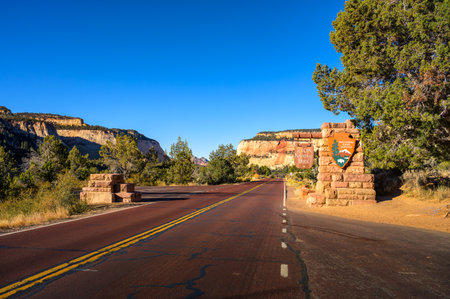 Zion National Park, Utah, USA - November 08, 2023 : Welcome sign at Zion National Park entrance with red rock cliffs and clear blue sky.のeditorial素材