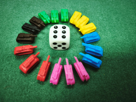 Dice and children's toys on green background. Toned.の写真素材